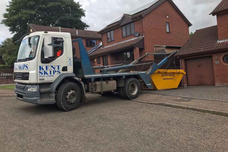 Kent Skips truck delivering a yellow skip bin in Norfolk