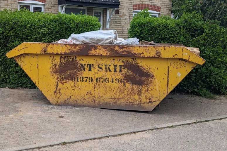 Full yellow Kent Skips bin with renovation waste - Skip Hire Suffolk